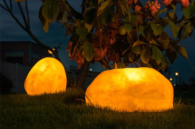 Custom Garden Stone Lights | Waterproof Illuminated Resin Rock Landscape Lighting 6 Warm glowing garden stone lights on grass, outdoor resin rock lamp night view